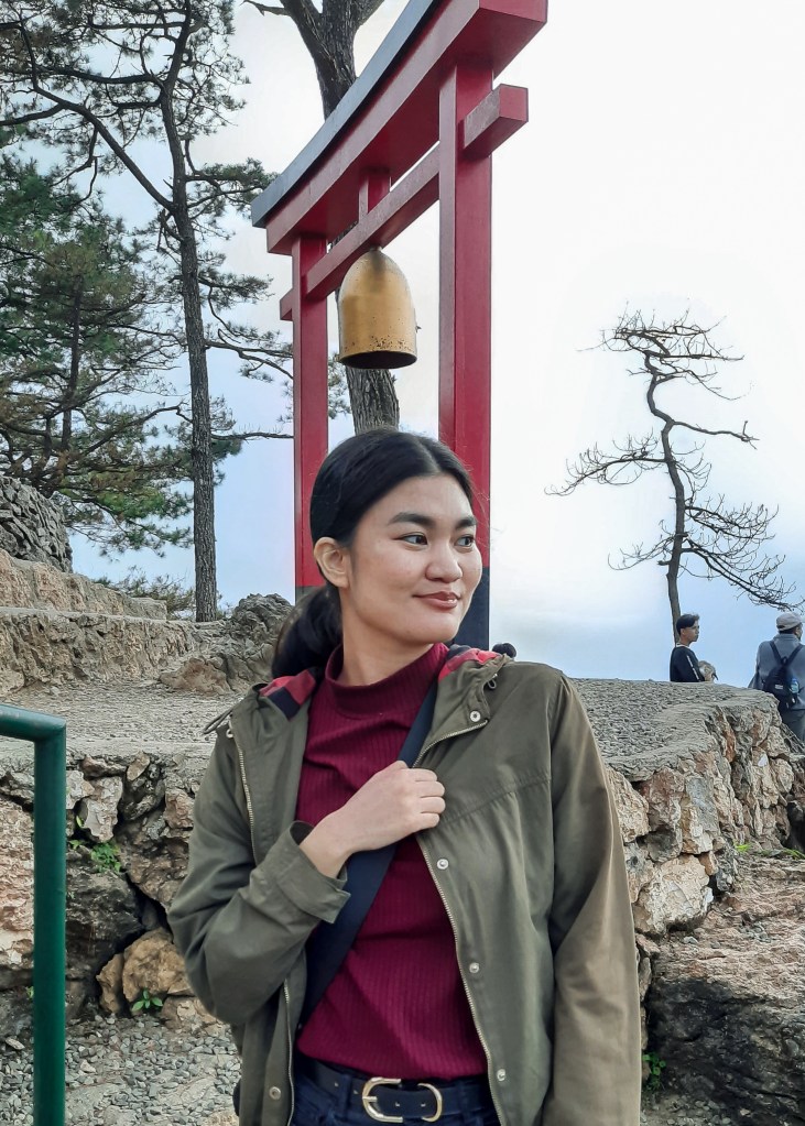 Girl posing in front of the torii gate found in Mirador Hill
