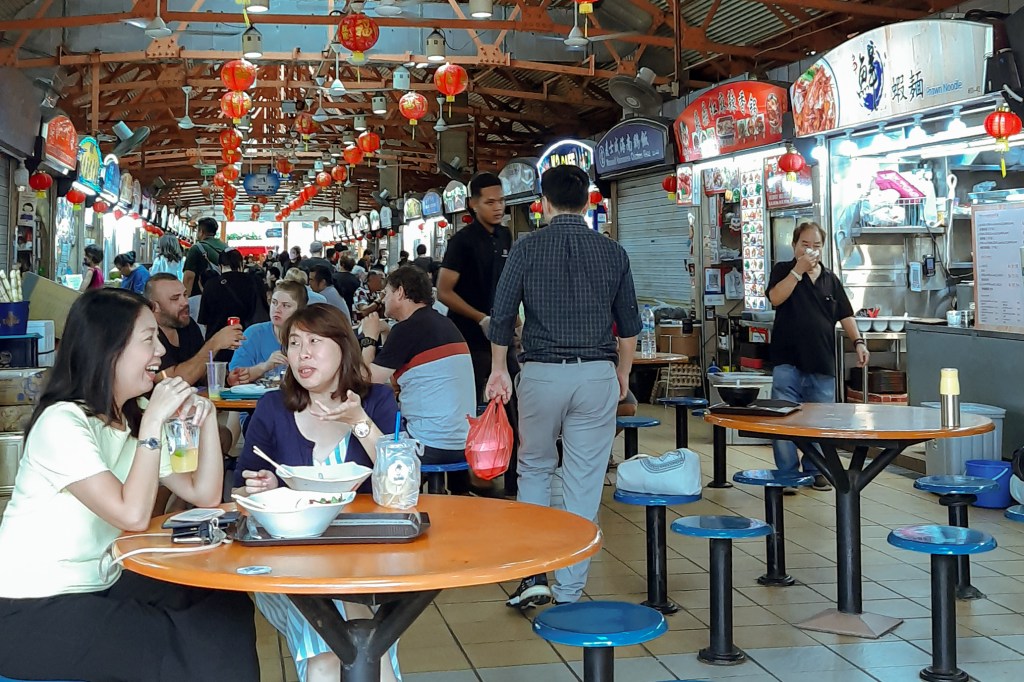People eating inside Maxwell Food Centre
