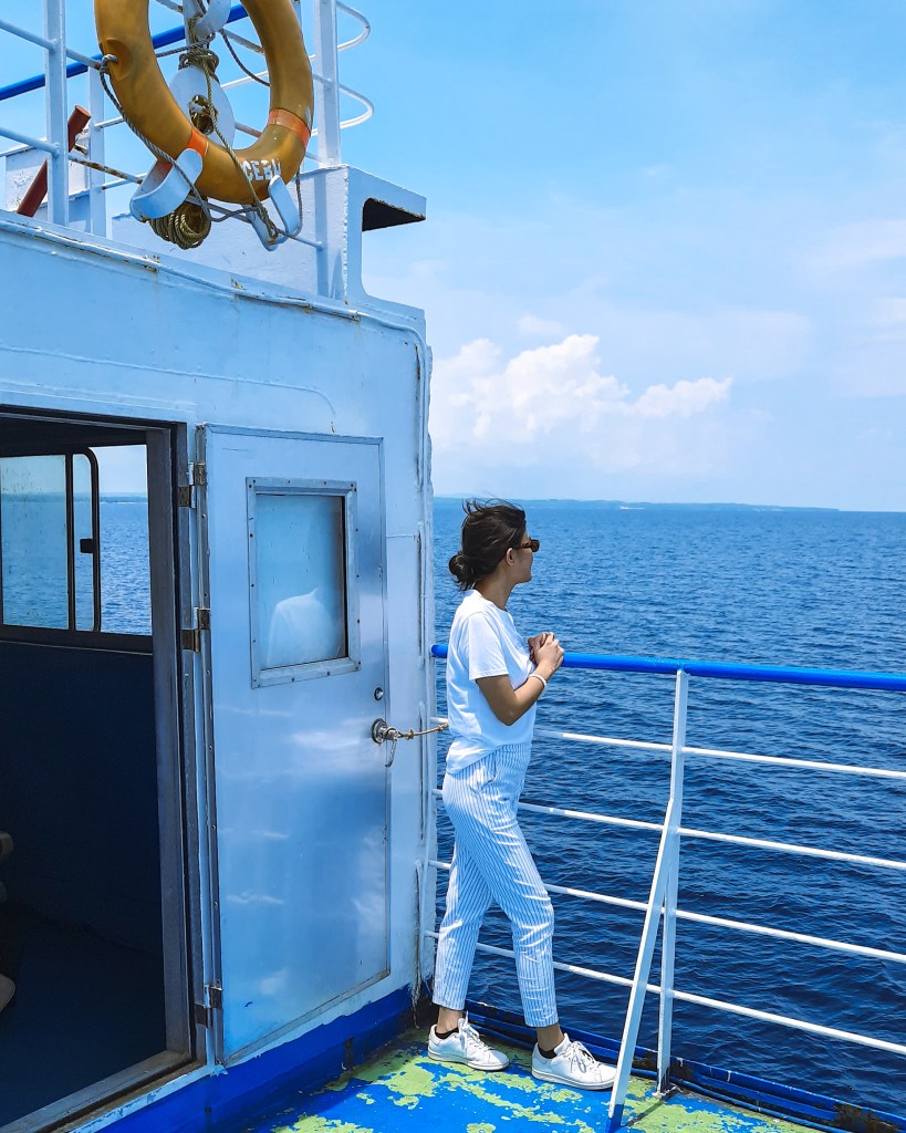 Girl standing by the railing of a ferry going to Sta. Fe, Bantayan Island