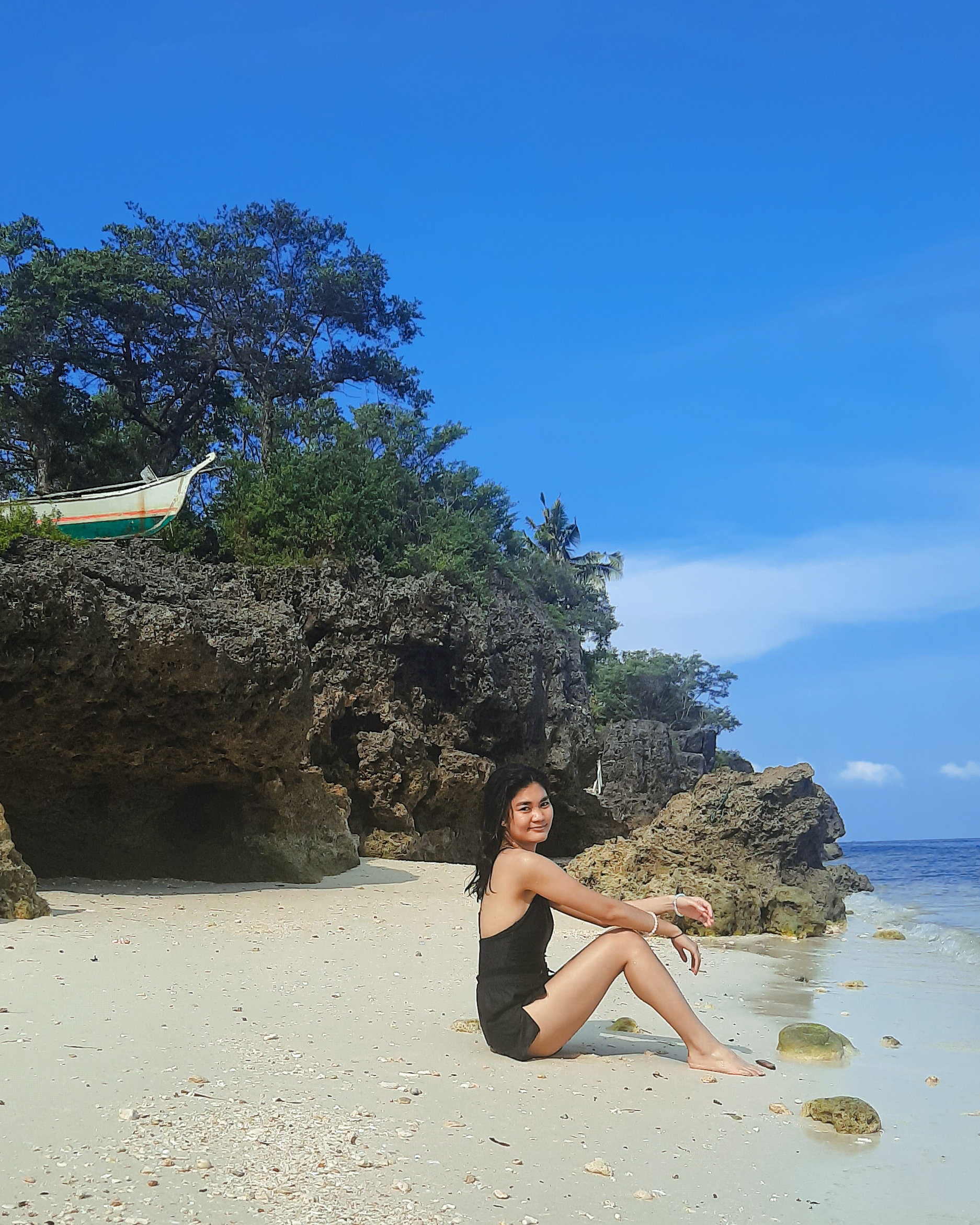 Girl lounging at Sandira Beach