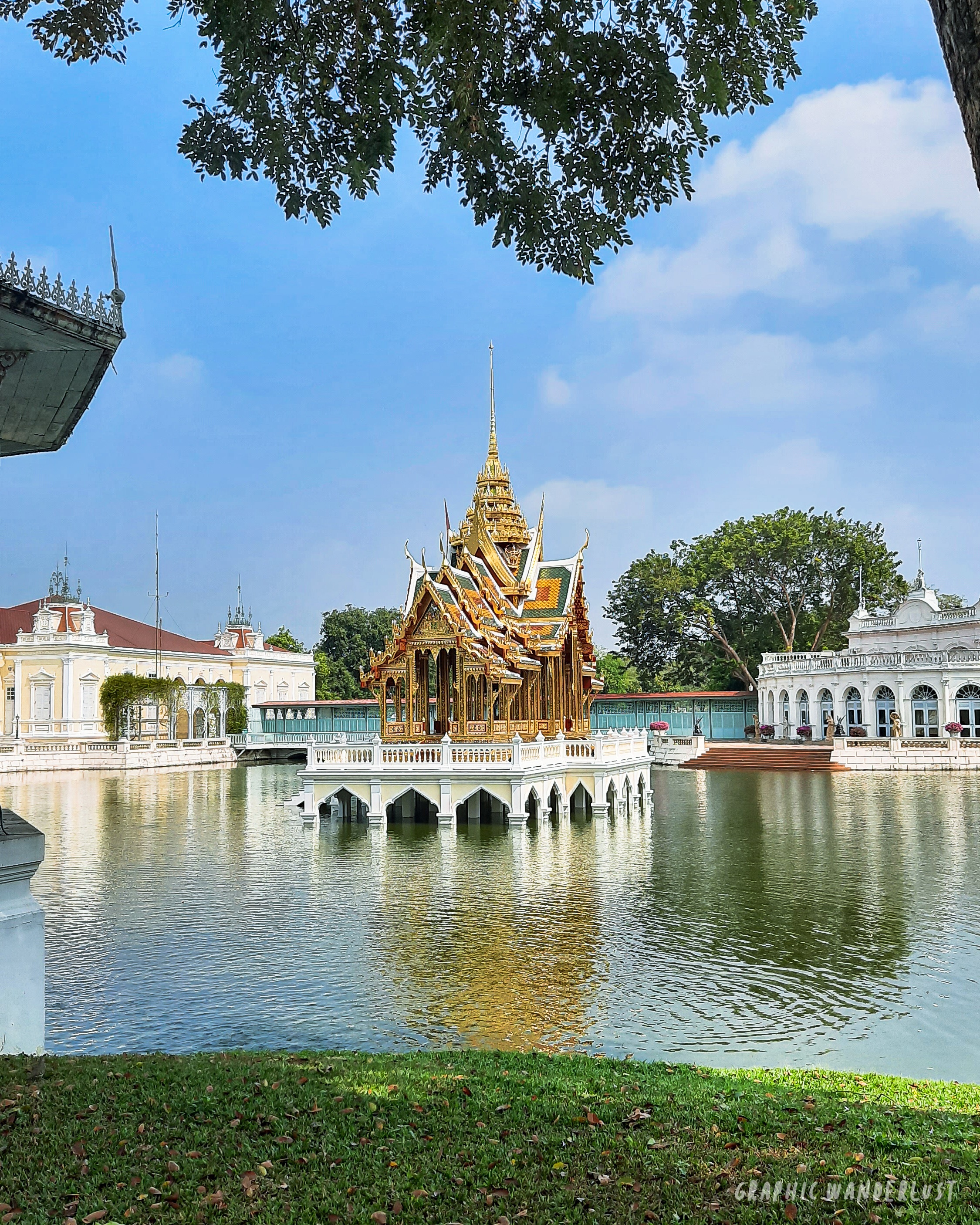 Man-made lake with a golden pavillion at the center and two neoclassical buildings surrounding it in Bang Pa-in Palace