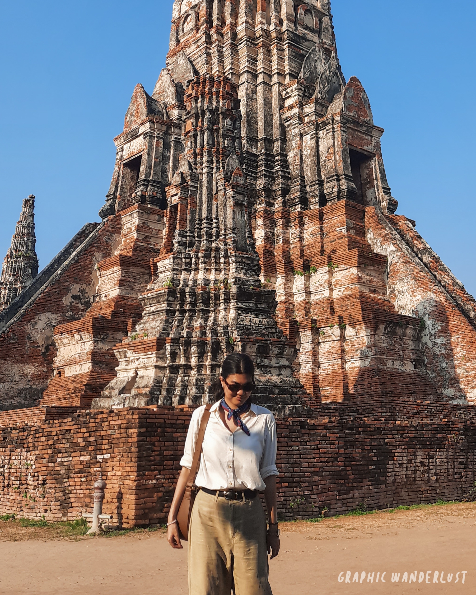 Girl standing in front of the main prang of Wat Chaiwatthanaram