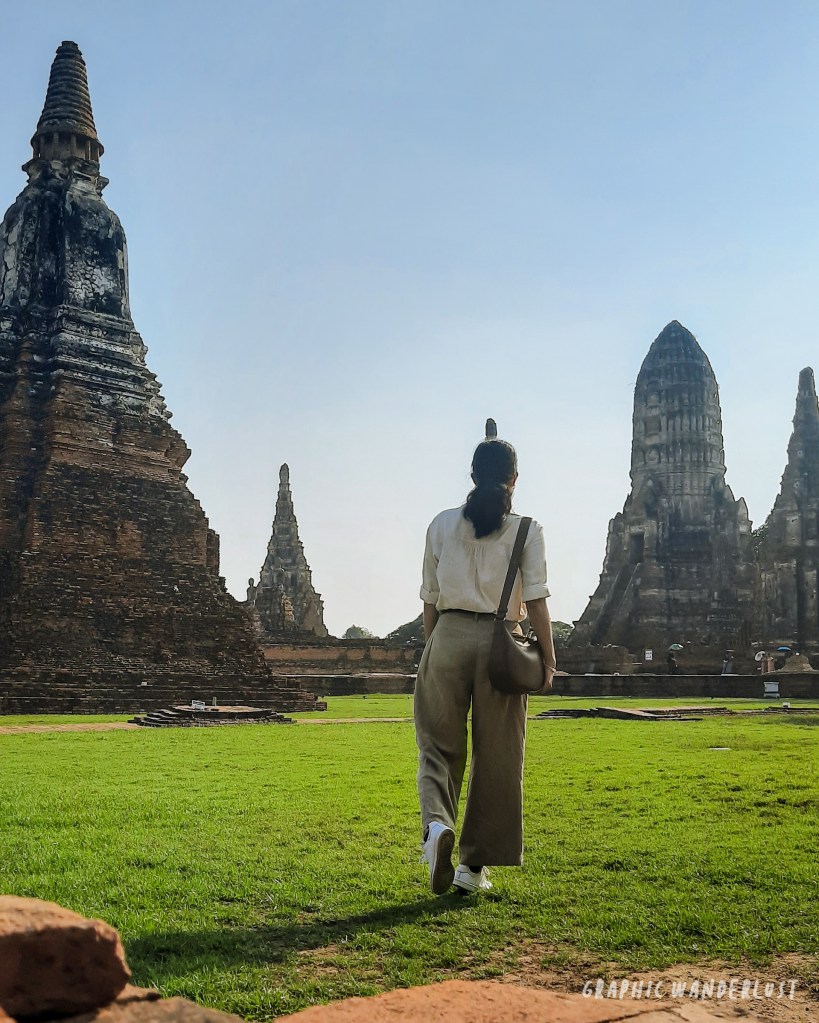Girl walking towards the stupas and prangs of Wat Chaiwatthanaram