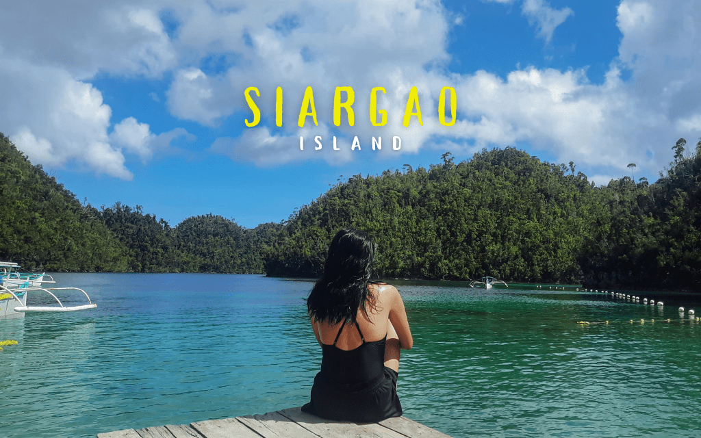Girl sitting on a deck fronting the cliffs of Sugba Lagoon in Siargao Island