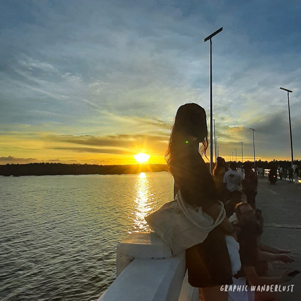 Girl watching the sunset at Catangnan Bridge