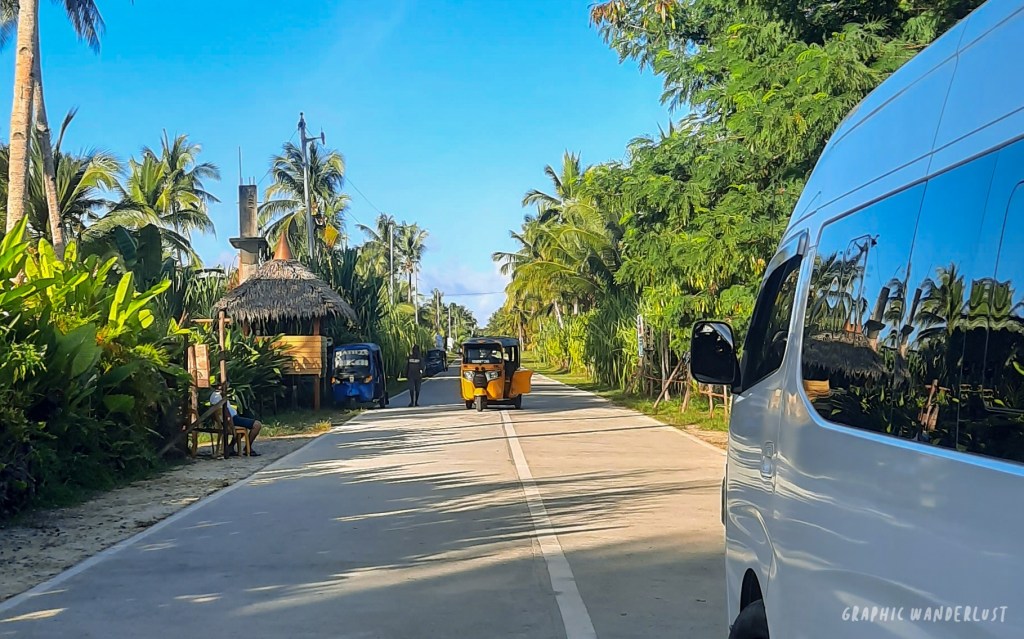 Tuktuk and tourist van along Tourism Road in Siargao Island.