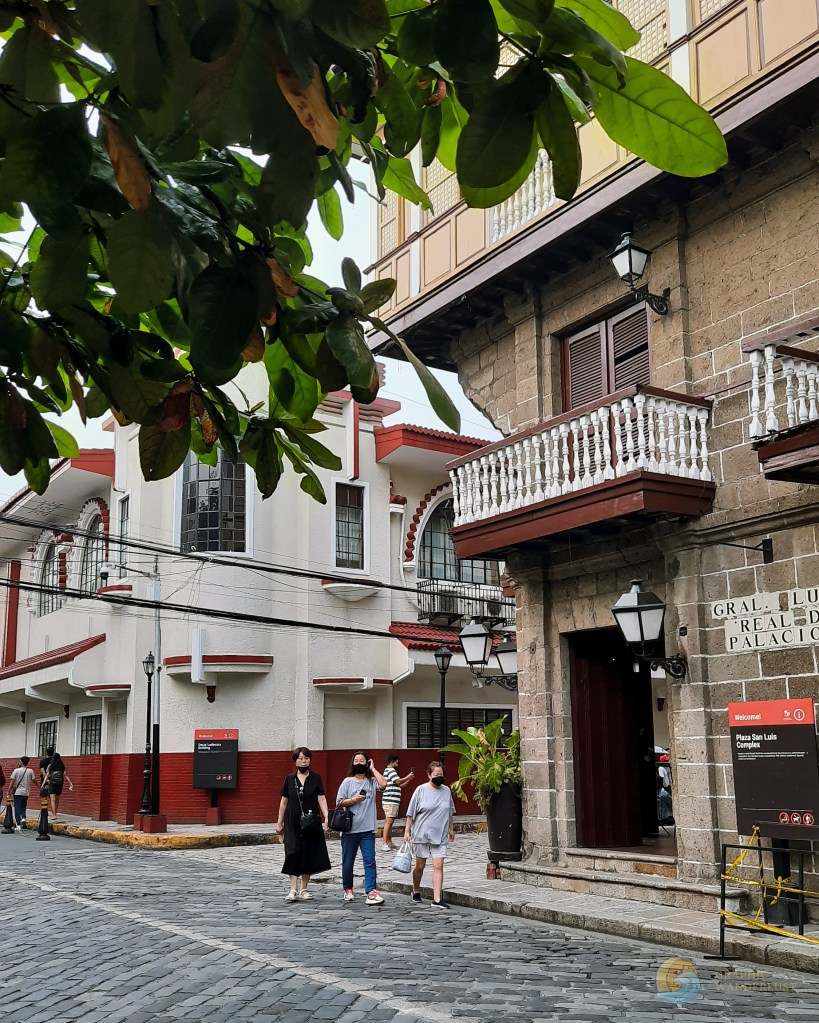 People walking at the corner of General Luna and Calle Real in Intramuros, Manila