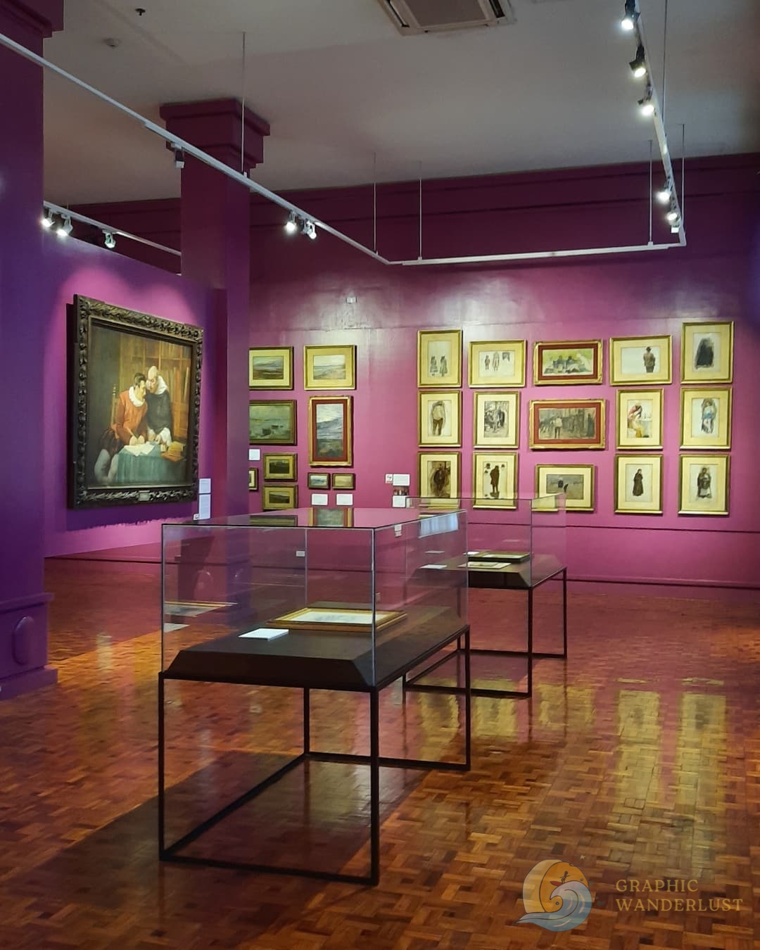 A gallery of paintings inside a museum