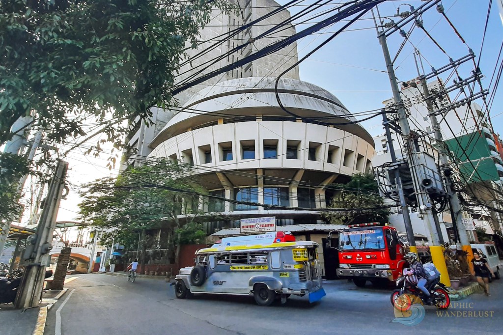 A traditional jeepney passing in front of Commercial Bank building in Escolta, Manila