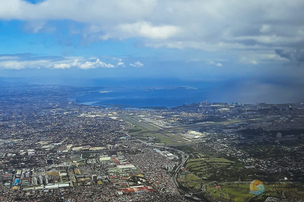 Bird's eye view of Metro Manila showing Manila Bay in the distance as seen from above