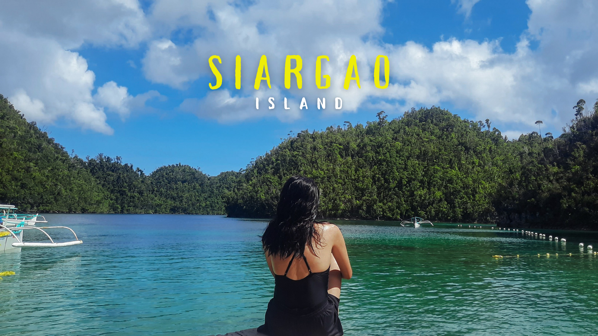 Girl sitting on a deck fronting the cliffs of Sugba Lagoon in Siargao Island