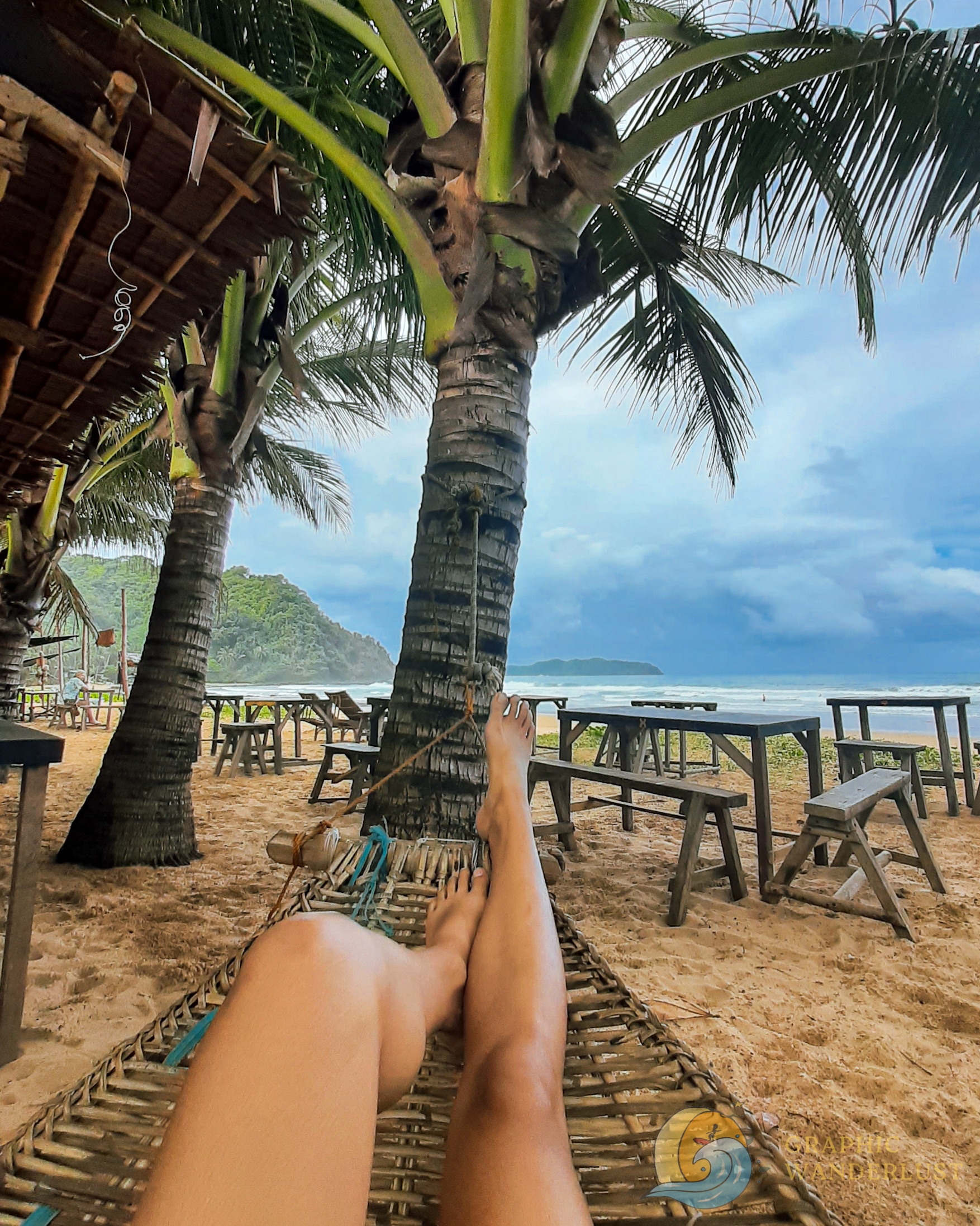 POV of a girl laying down on a hammock by the beach