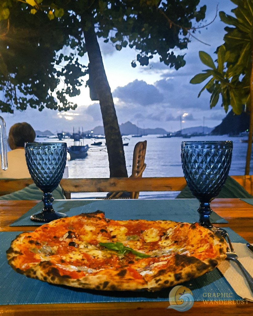 Serving of pizza with beachfront view