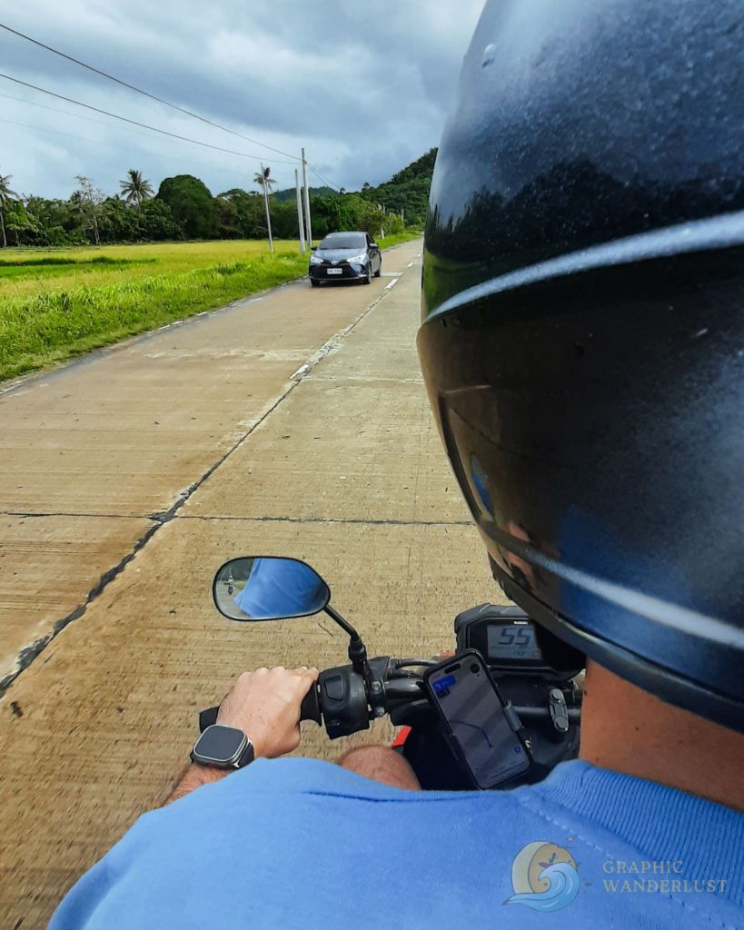 Over the shoulder shot of a man driving a scooter