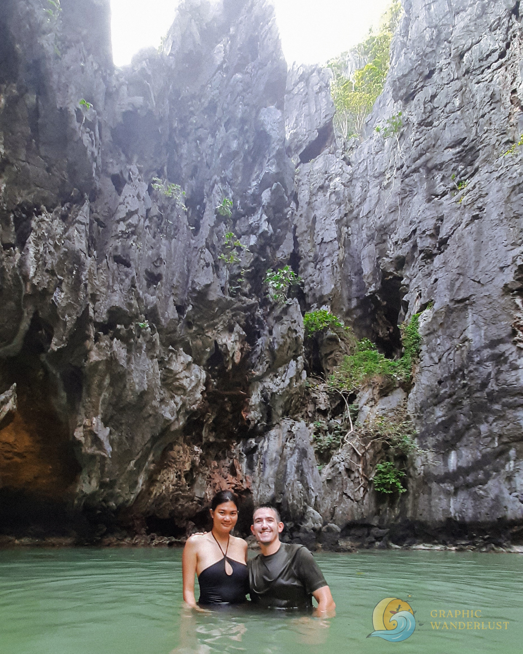 Two people submerged and standing inside a lagoon