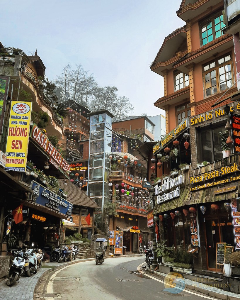 Lines of restaurants in local ethnic style with a curving street in between of them 