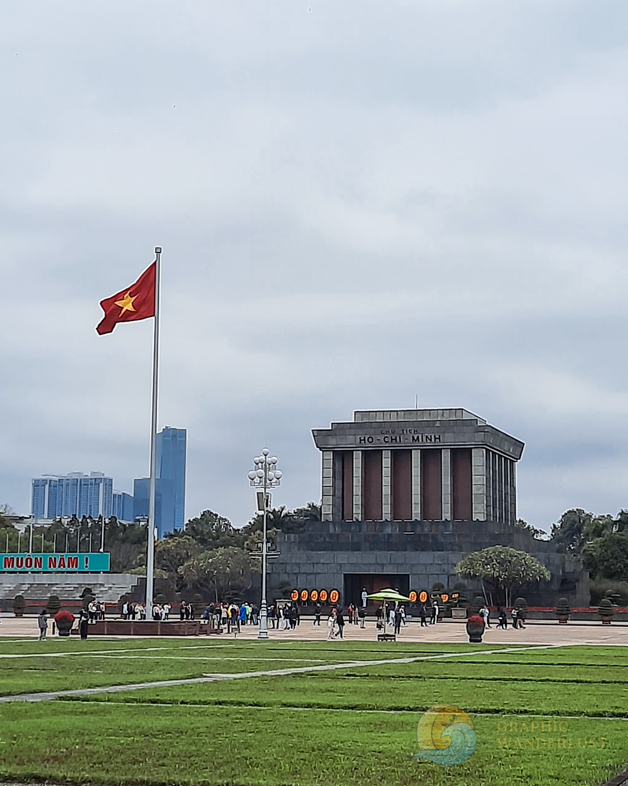 Brutalist landmark in Hanoi with the Vietnamese flag in front of it
