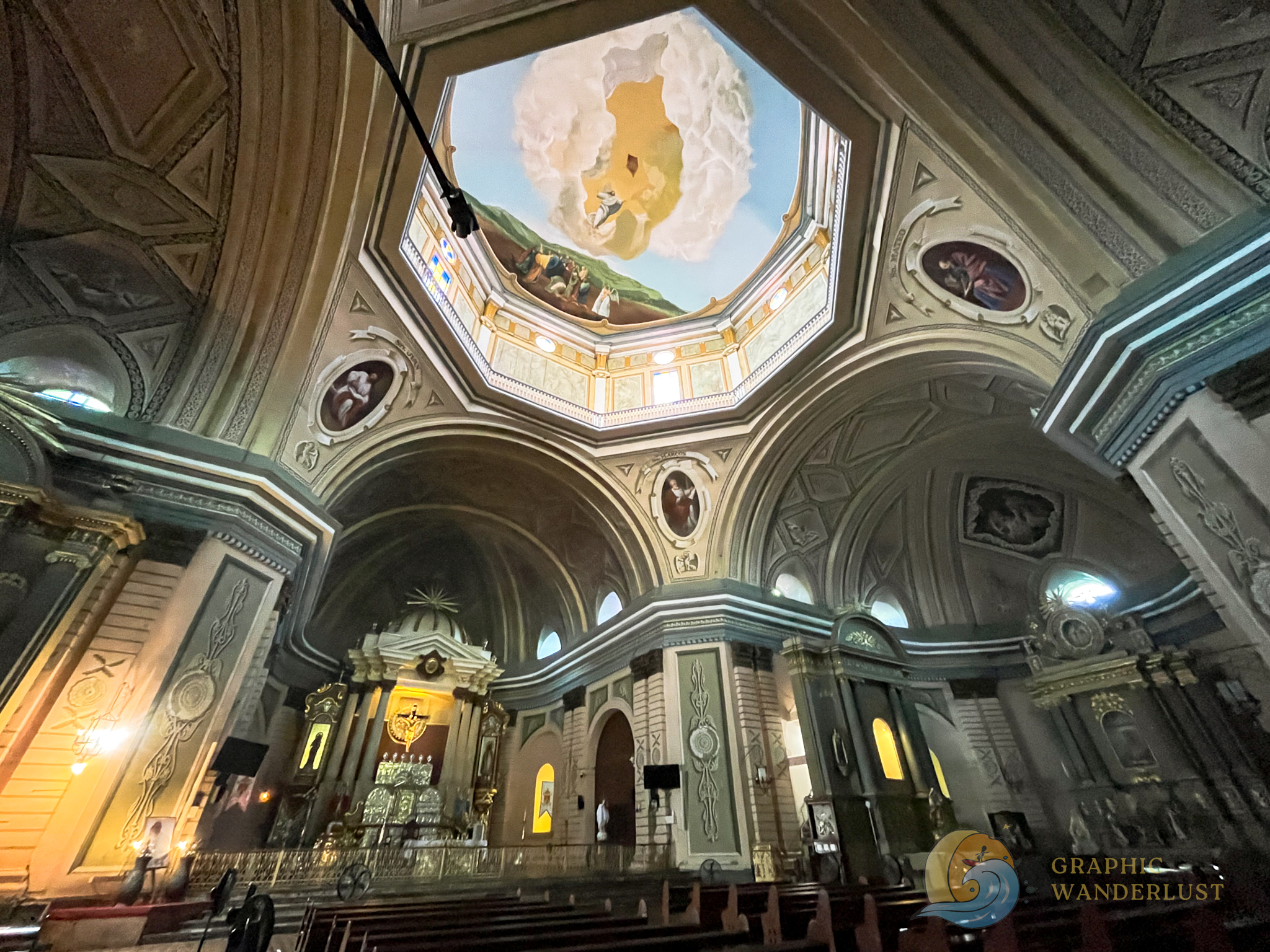 Trompe l'oeil celings of a church in Taal, Batangas featuring an octagonal dome at its center and the main altar at its bottom left.