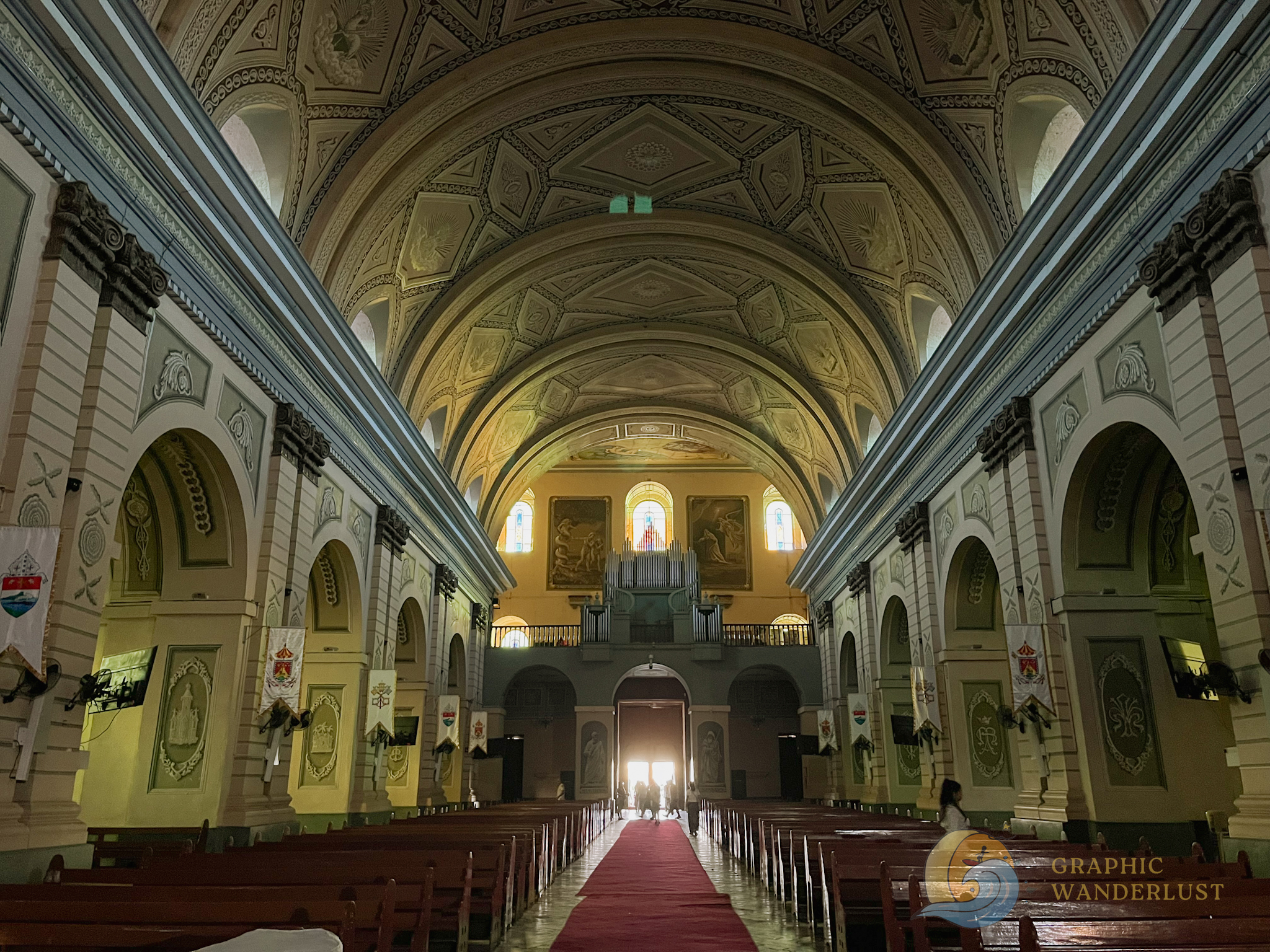 Interior of a church in Taal, Batangas featuring a barrel vaulted ceiling and arched walls adorned with trompe l'oeil art.