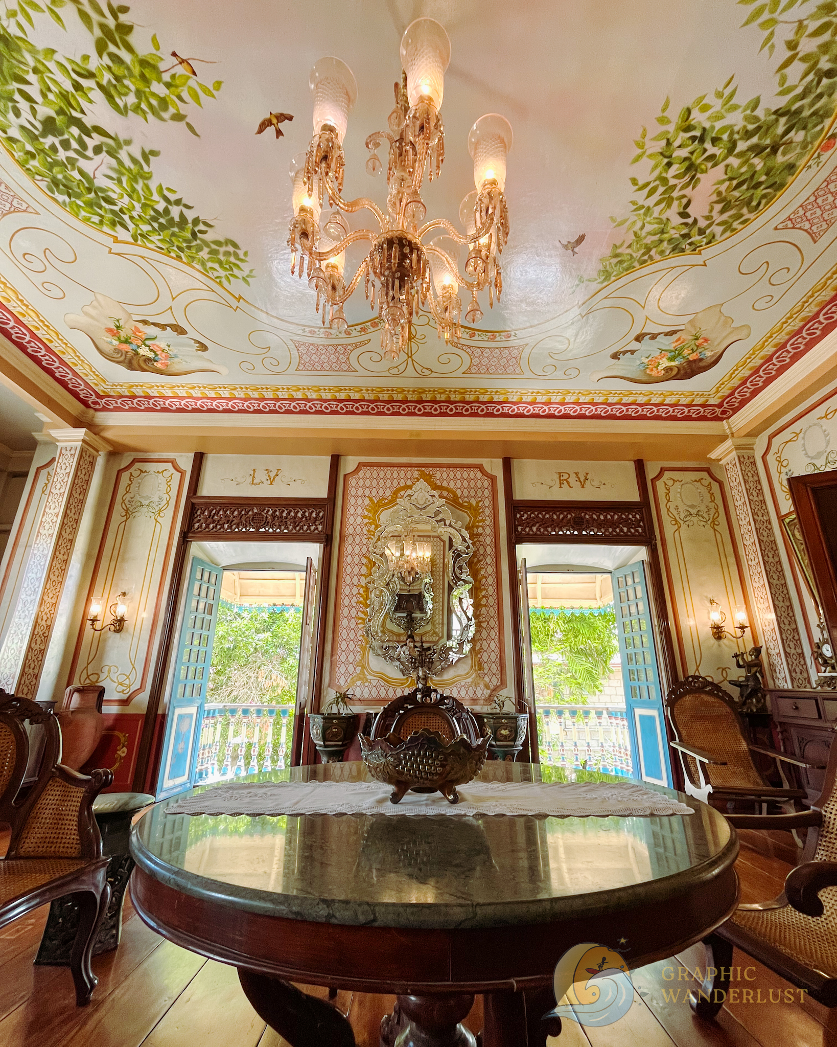 Interior of a Spanish colonial house adorned with hand-painted ceilings and walls and Spanish era furniture.