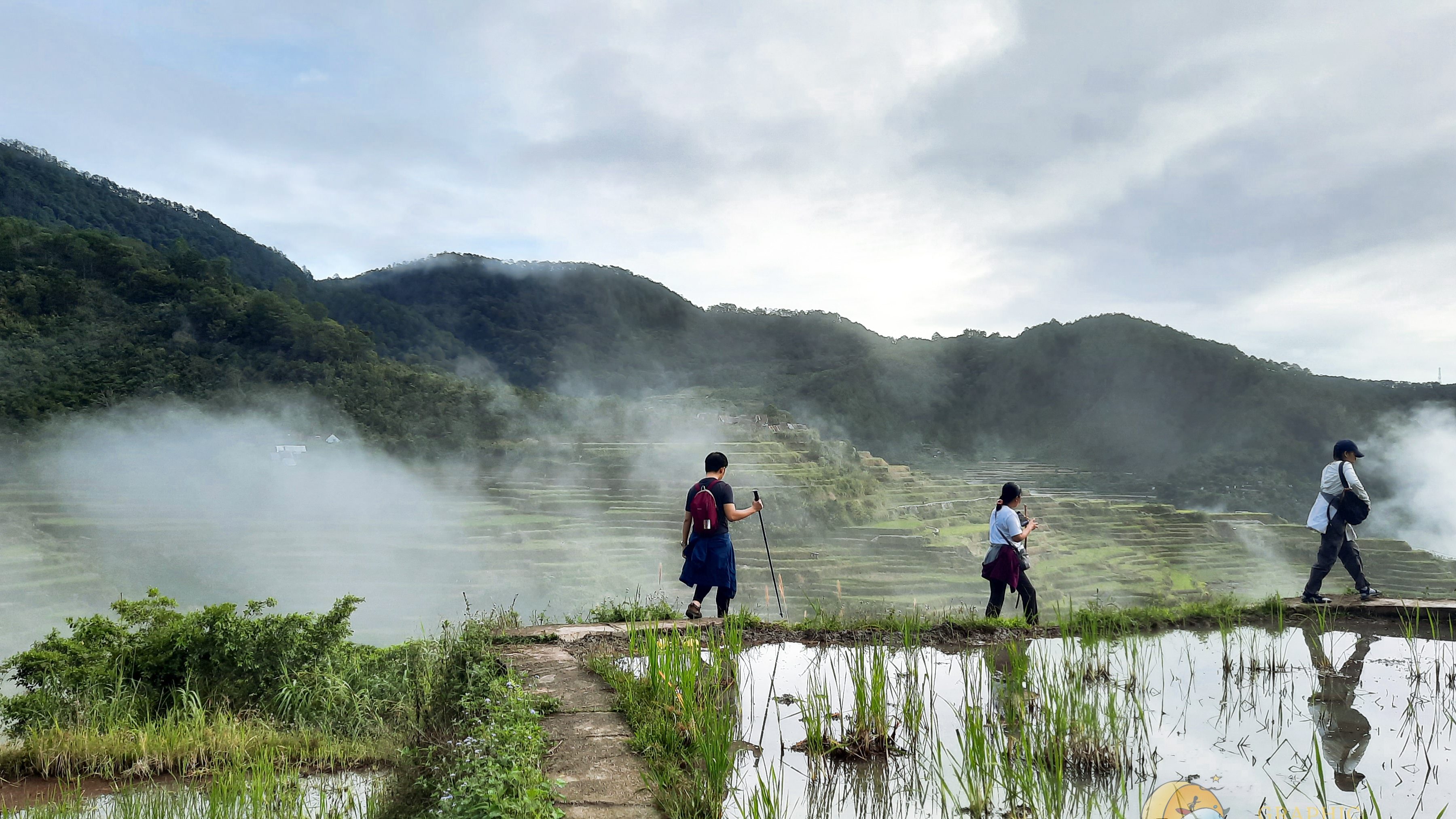 Hikers passing by in front of Maligcong Rice Terraces