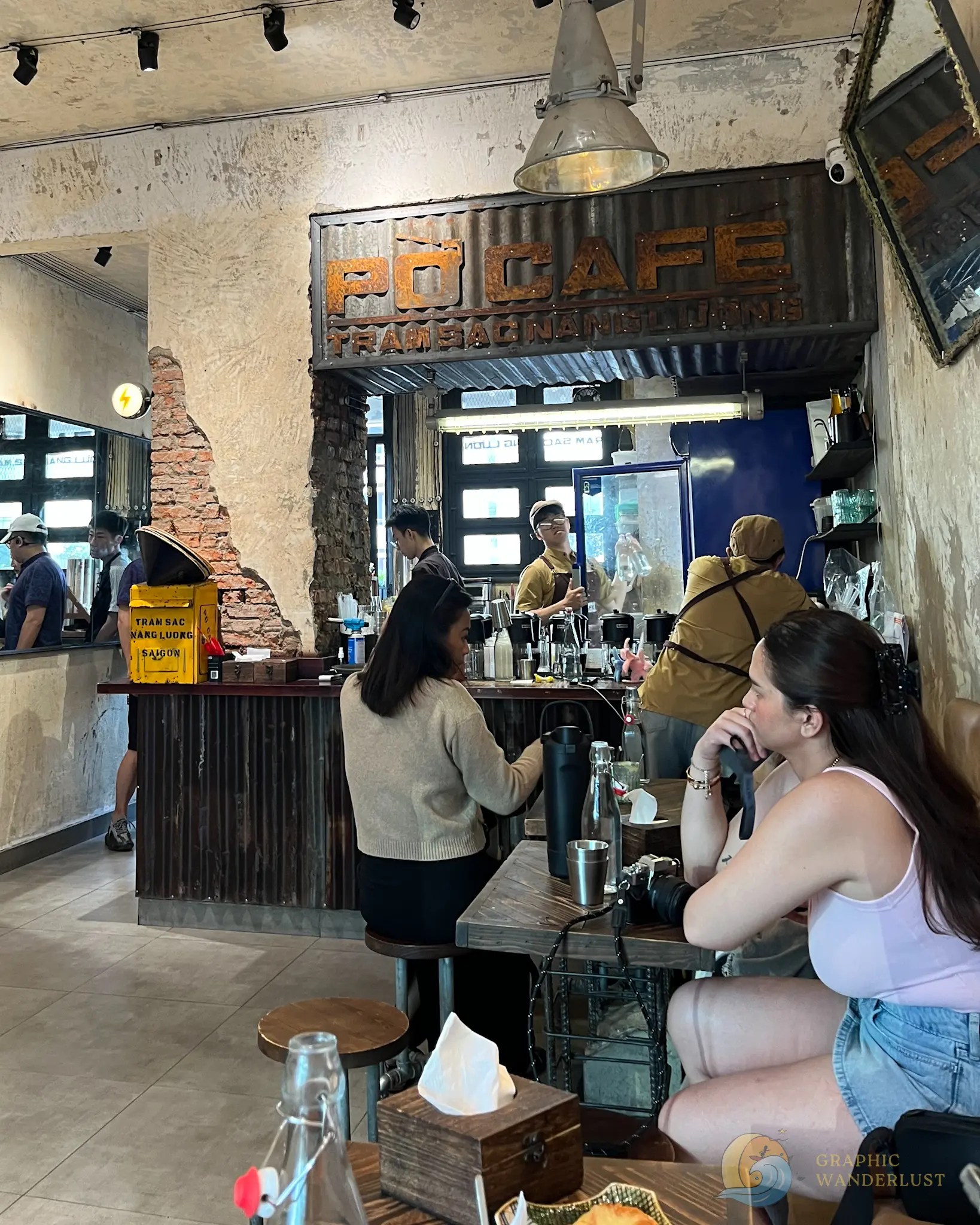 Interior of Po Cafe, featuring its counter and dining customers.