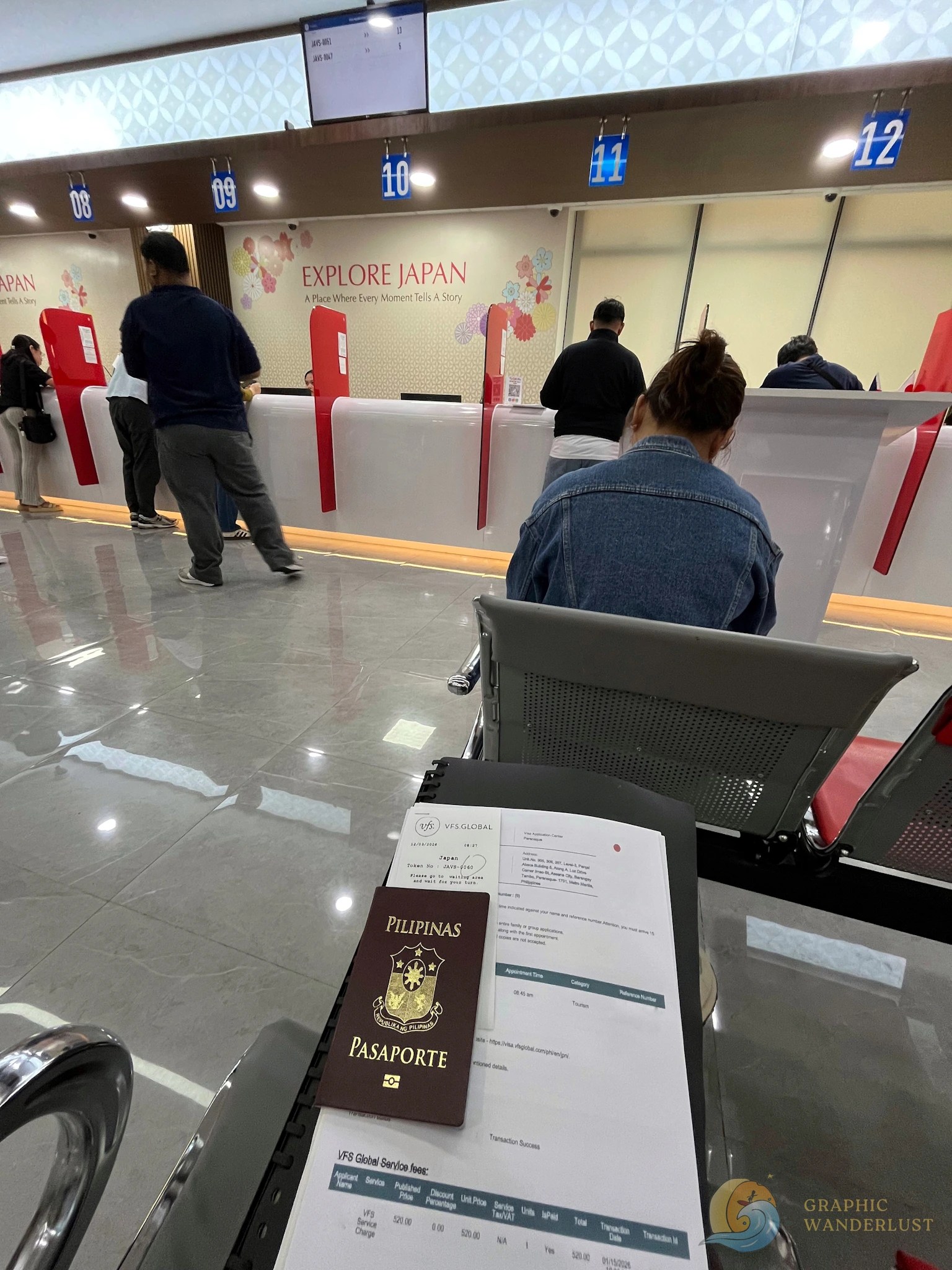 VFS Global Japan Visa Application Requirements Submission Philippine passport and documents at a VFS Global center with people at service counters in the background.