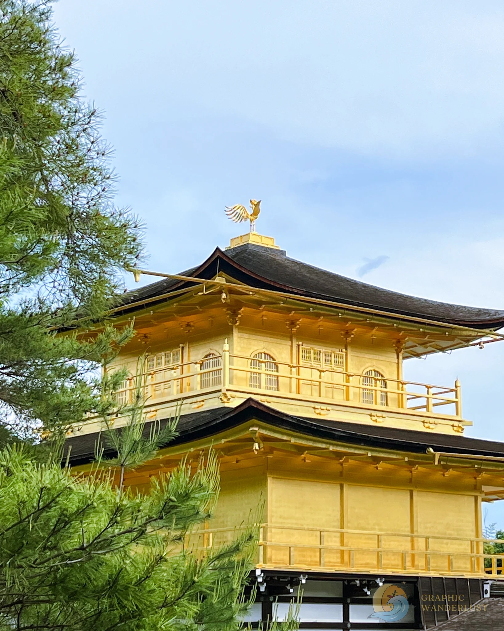 A golden pagoda highlighting the golden phoenix at the top of its roof.