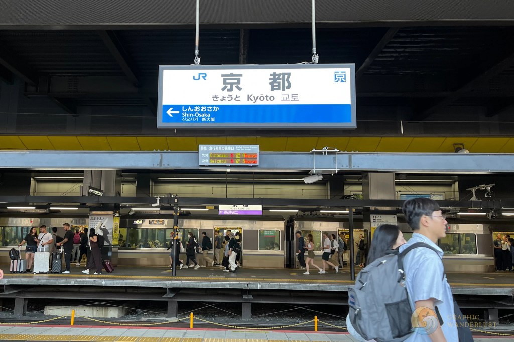 Kyoto train station platform with a sign showing directions to Shin-Osaka and display of next train cars reserved
