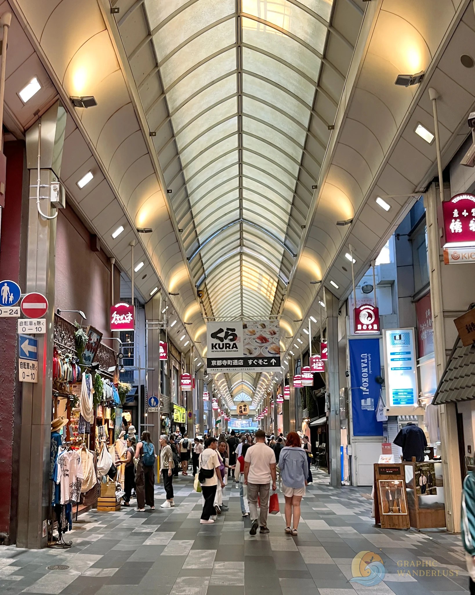 An interior of a shopping strip in Kyoto lined with various retail stores.