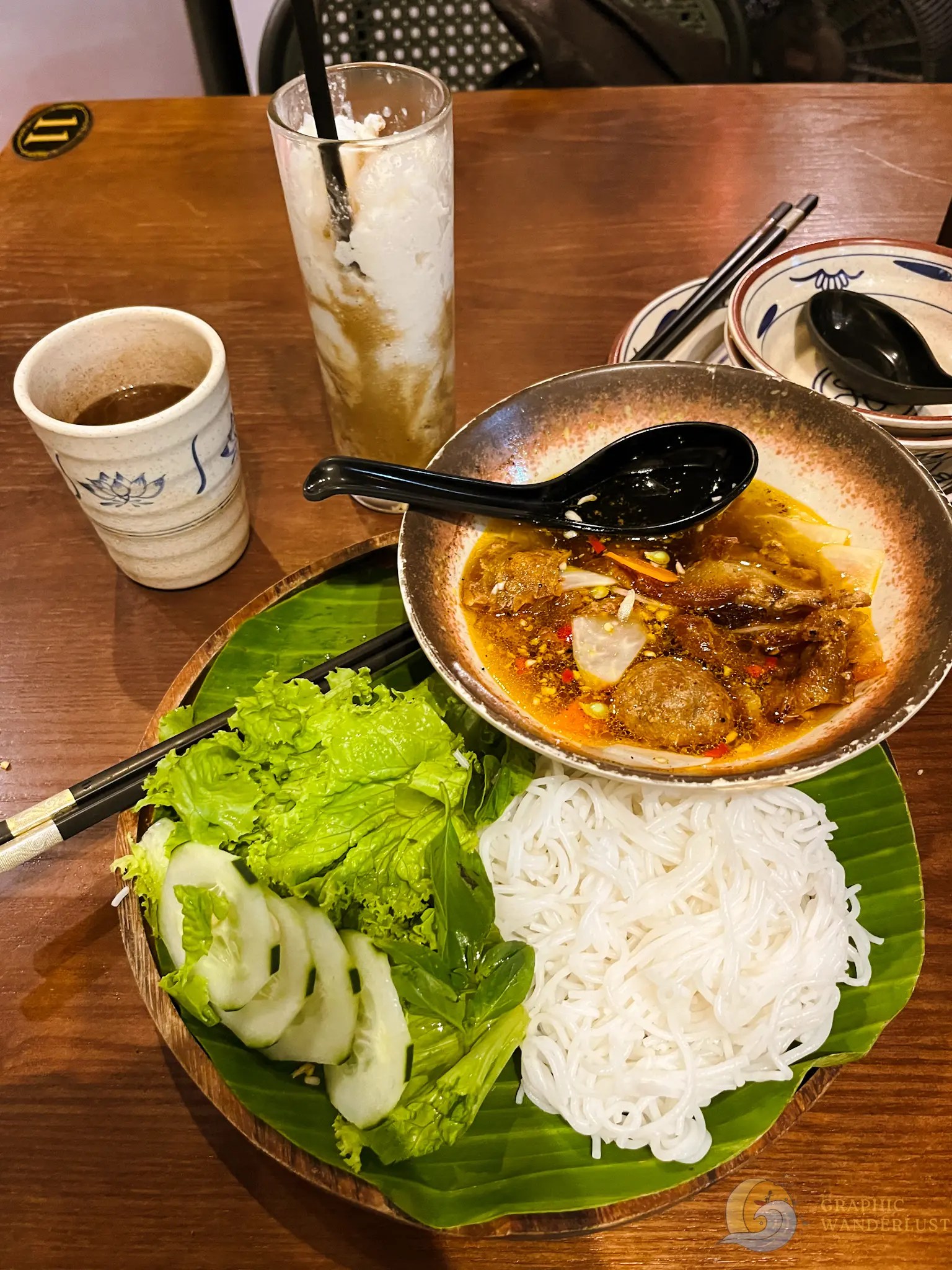Em Ha Noi Bun Cha Hanoi and Coconut Coffee Vietnamese meal with rice noodles, grilled meat in sauce, lettuce, cucumber, and iced drink